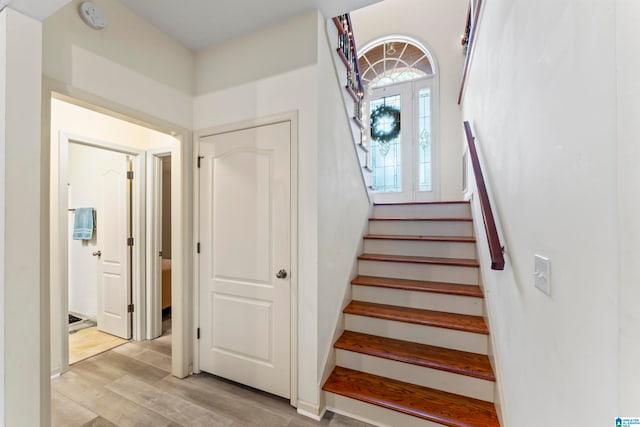 stairway with hardwood / wood-style flooring