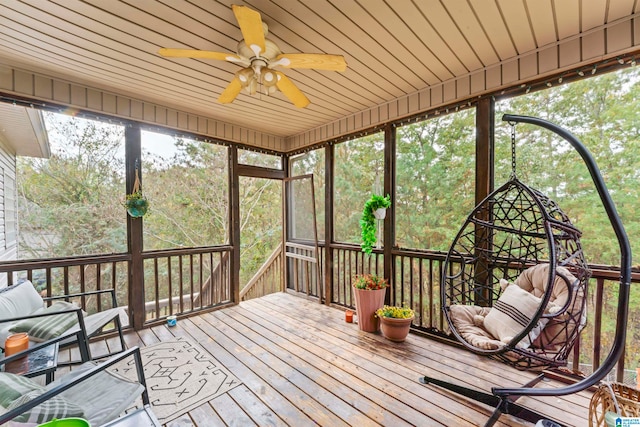 sunroom / solarium featuring ceiling fan and wood ceiling