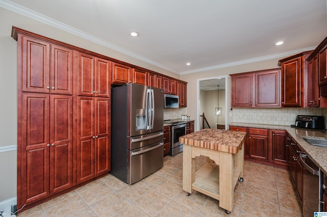 kitchen featuring stainless steel appliances, crown molding, light tile patterned floors, and decorative backsplash