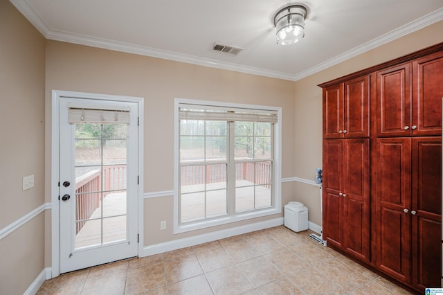 doorway with light tile patterned floors and crown molding