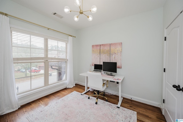 office area with hardwood / wood-style flooring and a notable chandelier