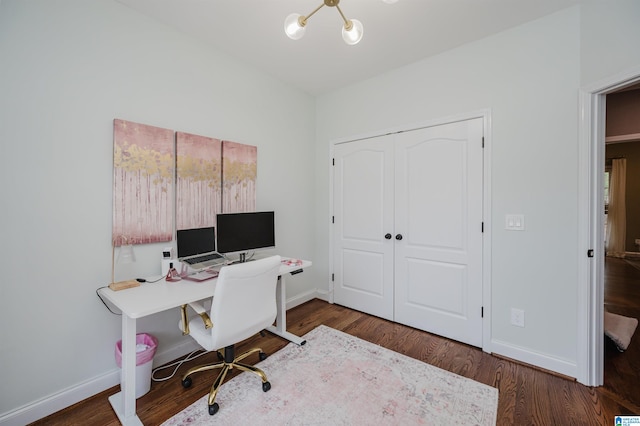 home office featuring dark hardwood / wood-style flooring and a chandelier