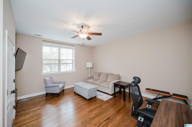 office space featuring ceiling fan and dark hardwood / wood-style floors