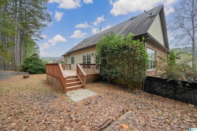 back of house with a wooden deck