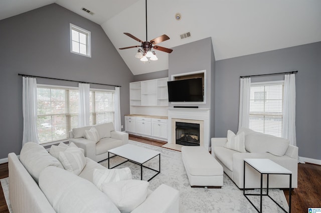 living room with high vaulted ceiling, plenty of natural light, wood-type flooring, and ceiling fan