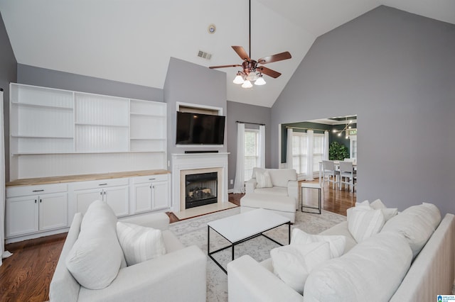 living room featuring high vaulted ceiling, light hardwood / wood-style flooring, and ceiling fan