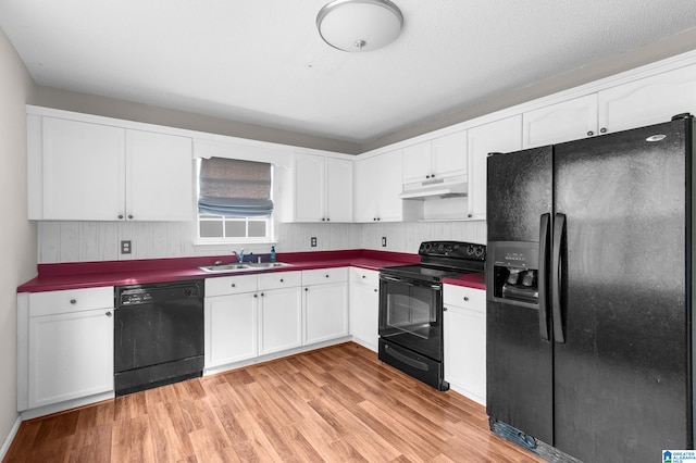 kitchen featuring black appliances, white cabinetry, sink, and light hardwood / wood-style floors