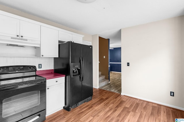 kitchen featuring white cabinetry, hardwood / wood-style floors, and black appliances