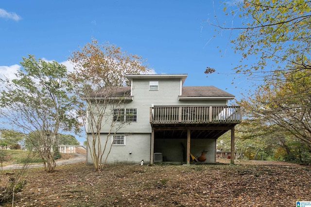 rear view of house with a wooden deck