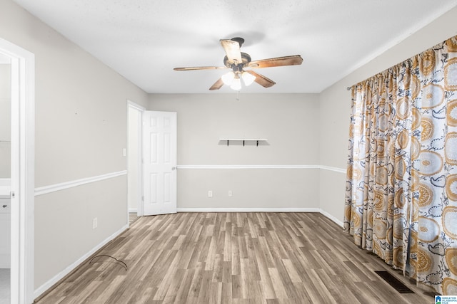 unfurnished room featuring light hardwood / wood-style floors and ceiling fan