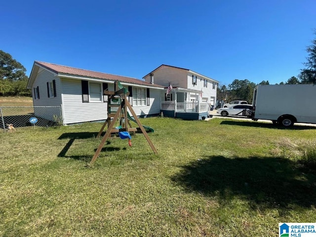 exterior space featuring a playground and a yard