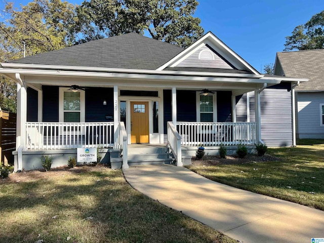 bungalow featuring a front lawn, ceiling fan, and covered porch