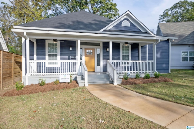 view of front of property with ceiling fan, a front yard, and a porch