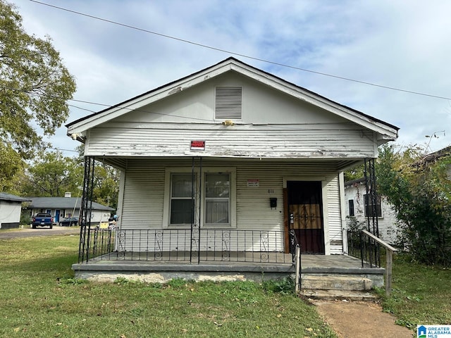 bungalow featuring a front yard and covered porch