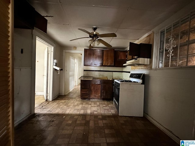 kitchen with ceiling fan, dark brown cabinets, and white gas range oven