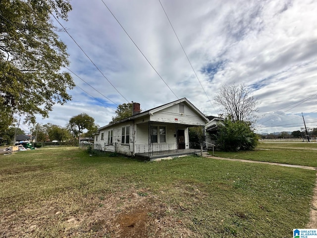 bungalow-style home with a front lawn and a porch