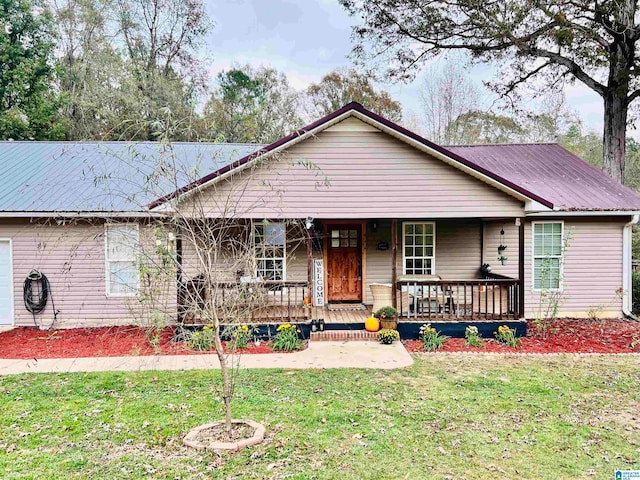 single story home with a porch and a front lawn