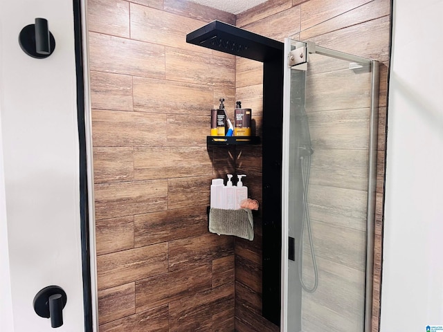 bathroom with walk in shower and wooden walls