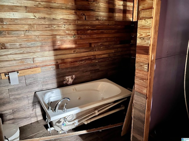 bathroom featuring wood walls