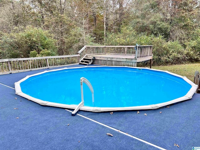 view of swimming pool featuring a wooden deck