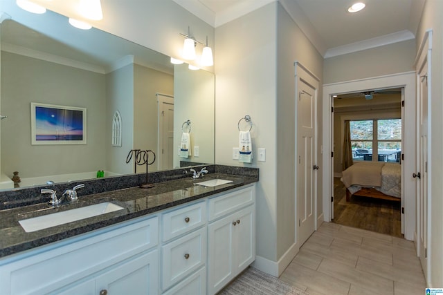 bathroom with hardwood / wood-style floors, vanity, and crown molding