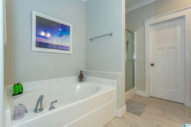 bathroom featuring crown molding and plus walk in shower