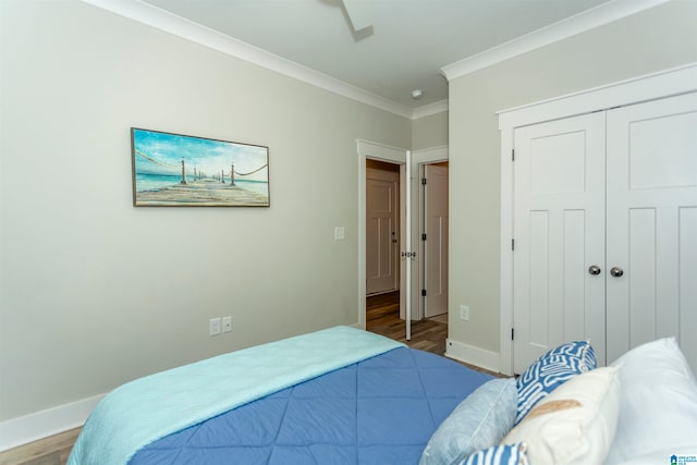 bedroom featuring ornamental molding, hardwood / wood-style floors, and a closet