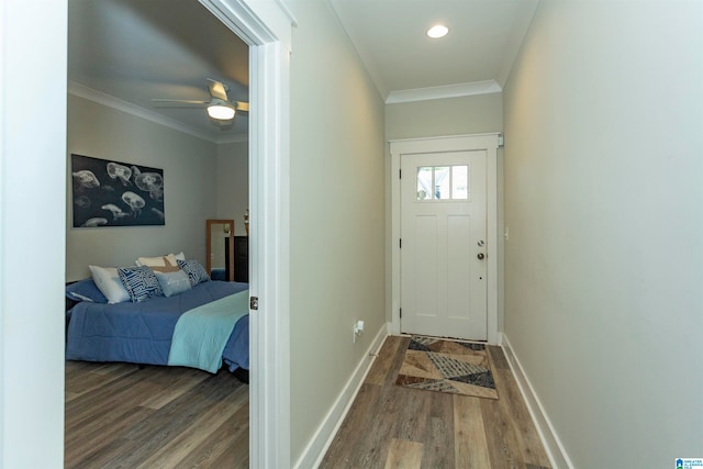 doorway to outside featuring dark hardwood / wood-style floors, crown molding, and ceiling fan