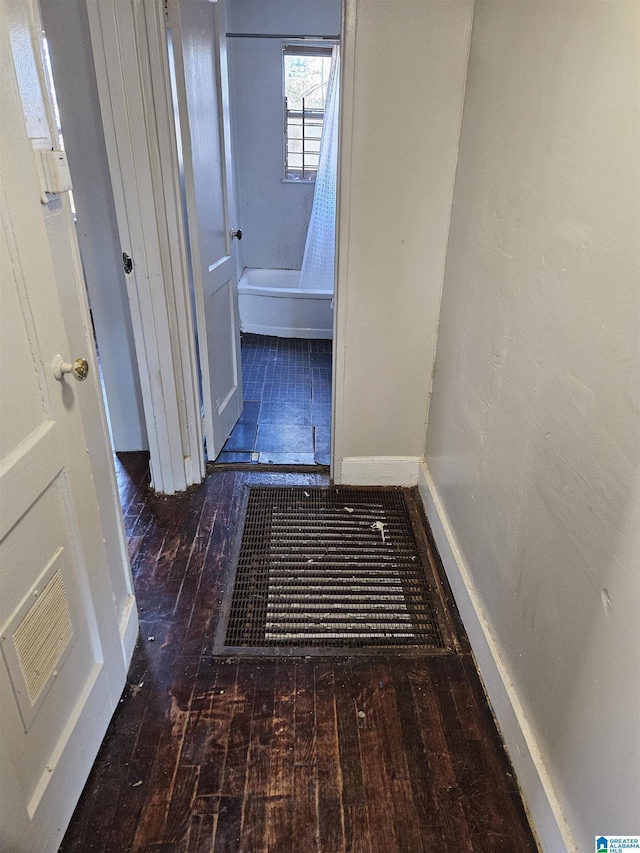 corridor featuring dark hardwood / wood-style floors