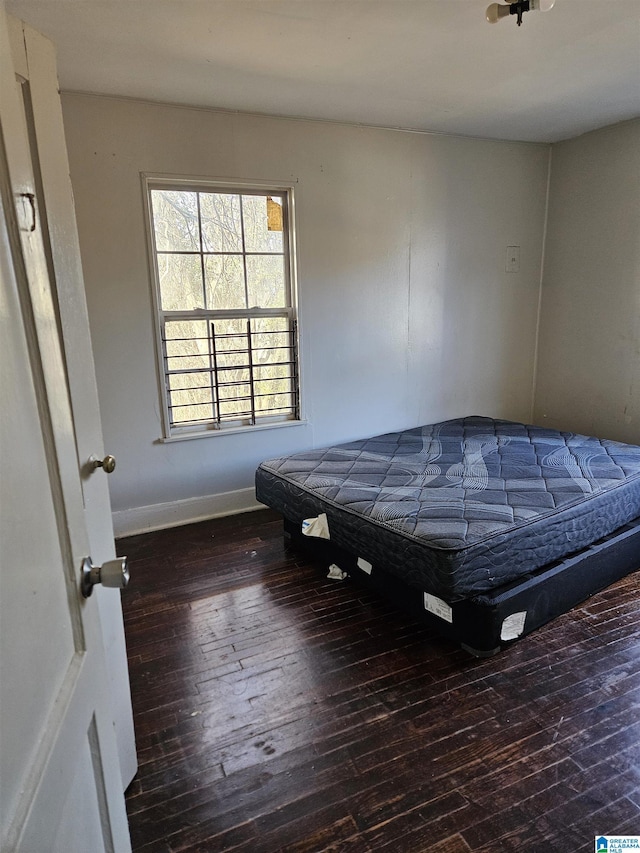 unfurnished bedroom with dark hardwood / wood-style floors