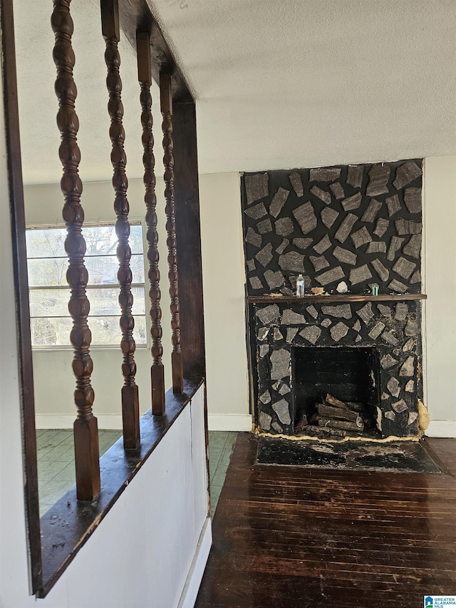 details featuring a fireplace, hardwood / wood-style floors, and a textured ceiling