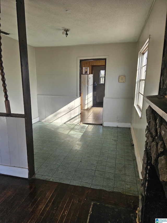 unfurnished room featuring dark hardwood / wood-style flooring and a textured ceiling