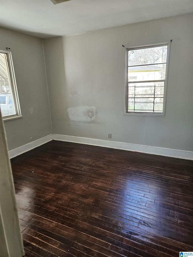 unfurnished room featuring dark wood-type flooring