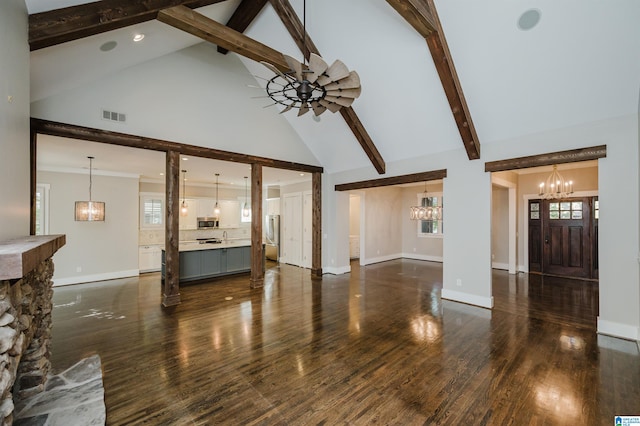 unfurnished living room featuring ceiling fan, dark hardwood / wood-style floors, beam ceiling, and high vaulted ceiling