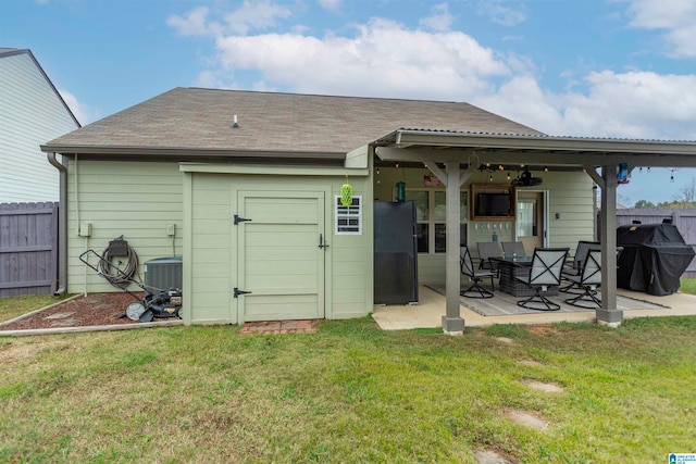 back of house featuring central air condition unit, a lawn, a patio, and ceiling fan