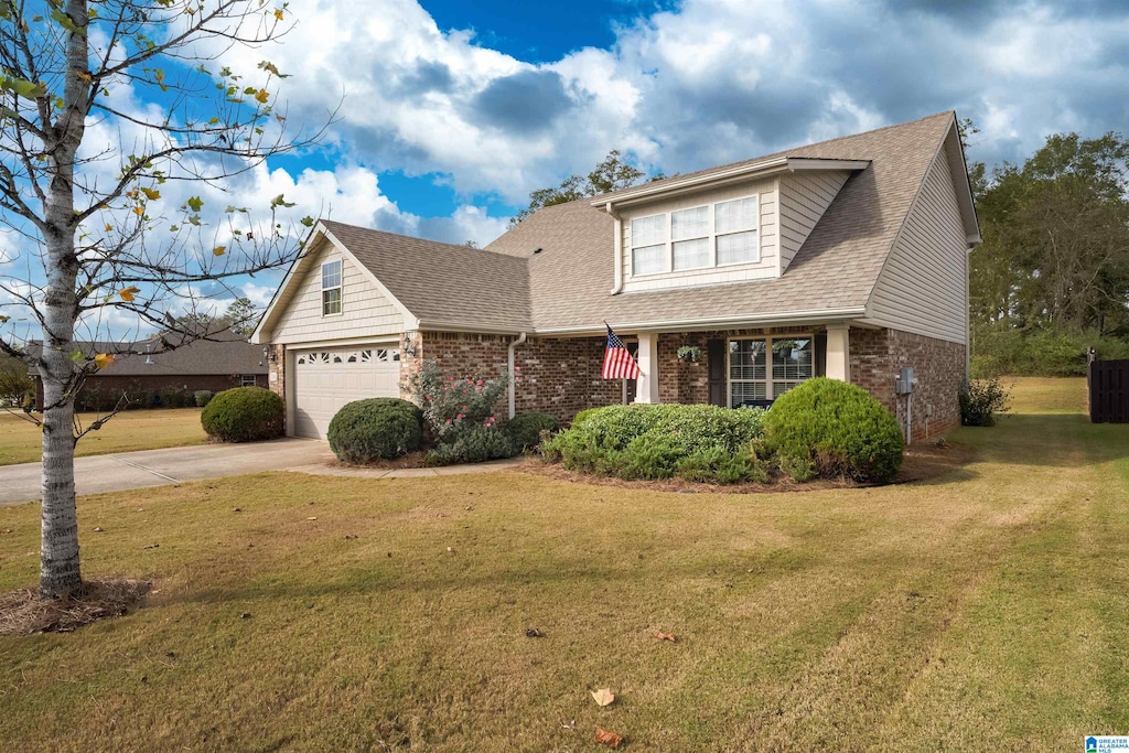 view of front of house with a front yard and a garage