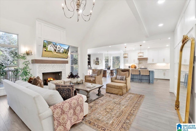 living room featuring a fireplace, light hardwood / wood-style flooring, and plenty of natural light