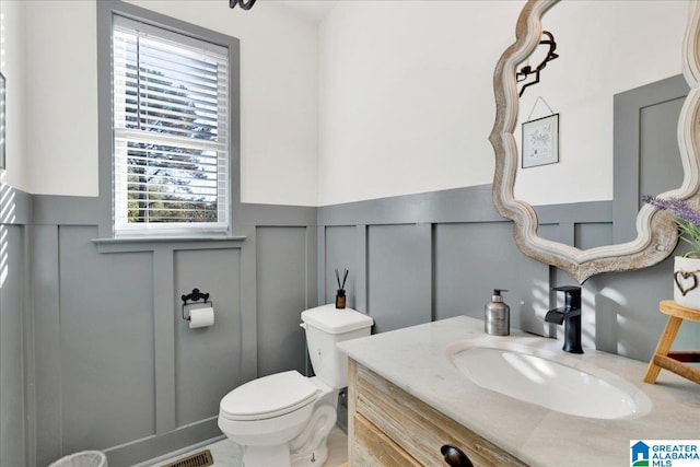 bathroom featuring vanity and toilet