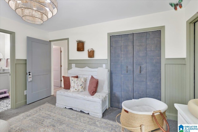 bedroom featuring carpet and a notable chandelier