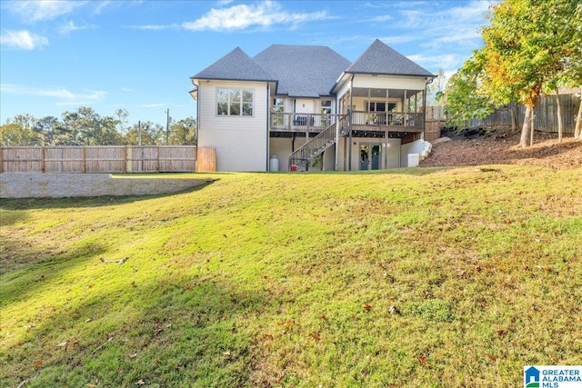 rear view of property with a yard and a deck