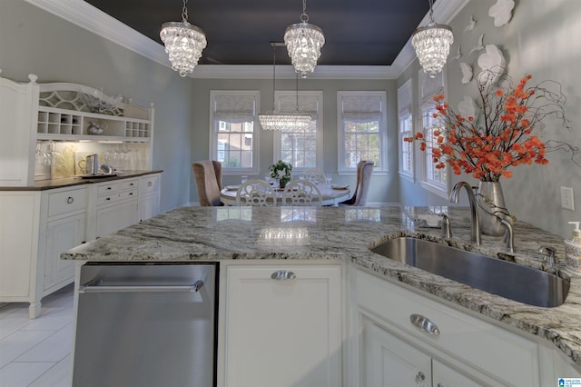 kitchen with light stone counters, crown molding, white cabinetry, light tile patterned floors, and sink