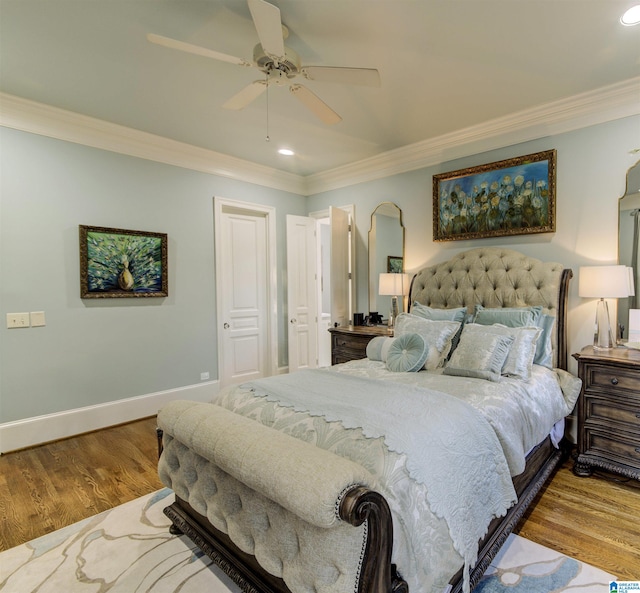 bedroom featuring ornamental molding, light hardwood / wood-style floors, and ceiling fan