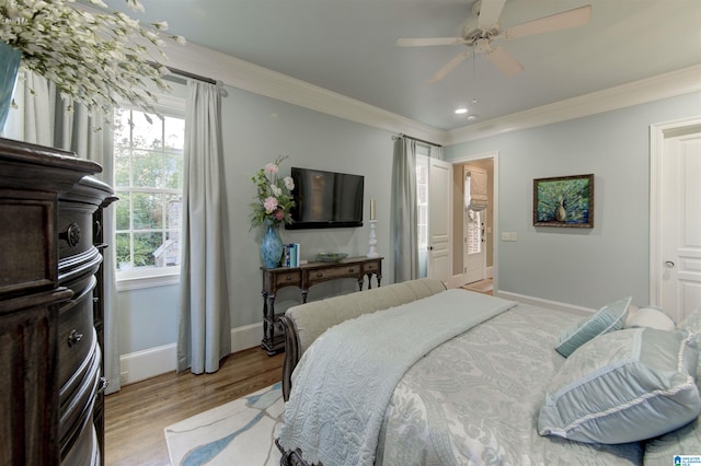 bedroom with ceiling fan, light hardwood / wood-style flooring, and crown molding