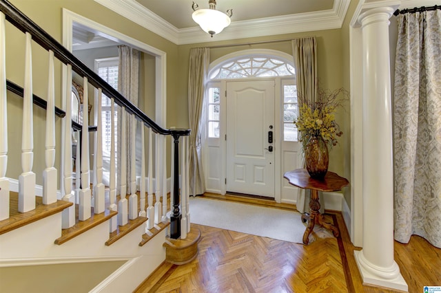 entrance foyer featuring ornamental molding, parquet floors, and ornate columns