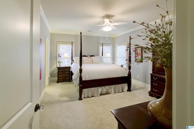 carpeted bedroom with ornamental molding and ceiling fan