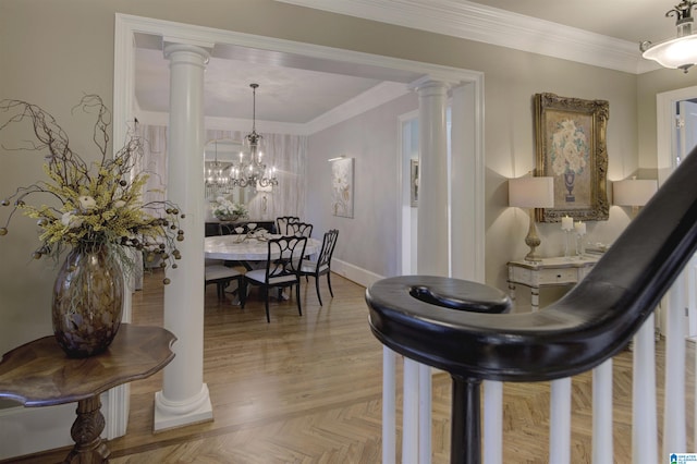 interior space featuring ornate columns, an inviting chandelier, and ornamental molding