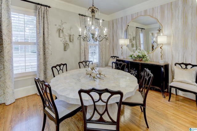 dining area featuring ornamental molding, a notable chandelier, and hardwood / wood-style flooring