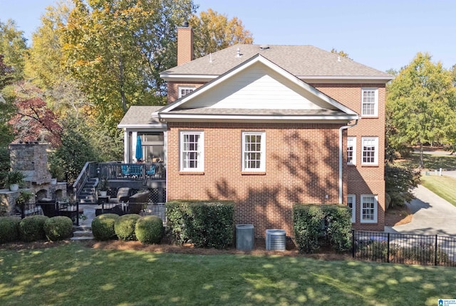 view of side of property with a lawn and a deck