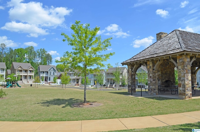 surrounding community with a playground, a lawn, and a gazebo