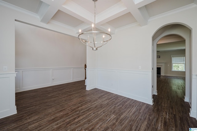 unfurnished dining area featuring beamed ceiling, dark hardwood / wood-style floors, crown molding, and coffered ceiling